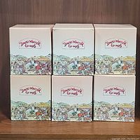 Six David Winter Groves collectible cottage boxes arranged in two rows of three on a wooden surface.
