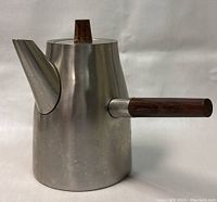 Front and side view of brushed stainless steel coffee pot with straight wooden handle and wooden lid knob.