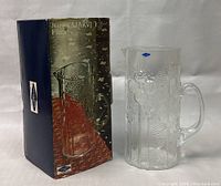 Glass pitcher shown with original box. Box has Nuutajarvi branding and shows the pitcher image.
