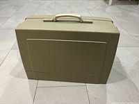 Closed beige carrying case for Kenmore sewing machine with handle on top.