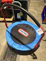 Front angle photo of Little Tikes 3-ft round trampoline with padded handlebar, foldable frame, blue trampoline cover and black jump surface with Little Tikes logo.