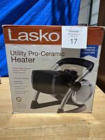Front side box view showing Lasko Utility Pro-Ceramic Heater with branding and features.