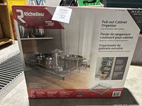 Photo of Richelieu pull-out cabinet organizer in original retail box with product images and branding visible.