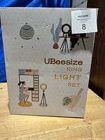 Closed box of UBeesize Ring Light Set with packaging illustration and branding visible.