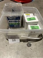 Plastic container with Tapcon and FitsFast screws in opened packaging.
