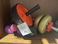 Photo showing ab wheel roller, two pairs of 3 lb purple dumbbells and adjustable dumbbell