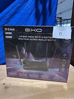 Front view of the sealed D-Link EXO AX1800 Mesh Wi-Fi 6 Router box showing router image and branding.