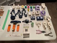 Full overhead view of all scrapbooking tools laid out on a white table showing various punches, stamps, and accessories
