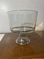 Side view of clear glass trifle bowl on pedestal base showing shape and size.