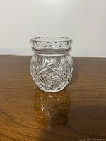 Front view of crystal sugar jar showing detailed cut-glass patterns.