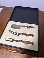 3 Piece Cheese Set in original box showing all utensils with wood handles and metal blades.
