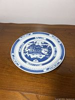 Full view of the vintage Chinese export porcelain plate showing central scene and outer border patterns.