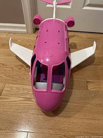 Front view of the pink Barbie Dream Plane showing the cockpit and seating inside for dolls.