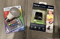 Photo of iHome Bluetooth clip-on speaker in packaging and Electra colour changing LED light bulb with remote in packaging, both new.