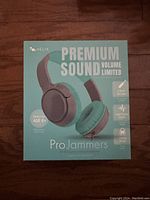 Front of the sealed Helix Pro Jammers headphone box highlighting premium sound, volume-limiting, 3.5mm aux jack, cloud cushions, and adjustable headband