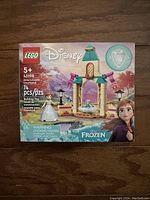Front view of the sealed LEGO Disney Frozen Anna's Castle Courtyard set box showing 74 pieces, Anna mini-doll, and castle courtyard build.