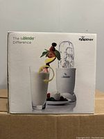 Front of box showing Isagenix Isablender with smoothie and ice-filled blending cup, highlighting product size and presentation.