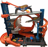 Front view of the three-level Hot Wheels Ultimate Garage with orange spiral tracks, working lift, and Hot Wheels signage on top.