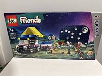Front view of LEGO Friends Stargazing Camping Vehicle box, showing set artwork featuring camping vehicle, figures, and starry night background