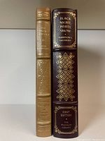Spines of two leather-bound Franklin Library books showing gilt titles and decoration.
