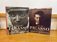 Photo of two hardcover books in the 'Life of Picasso' series by John Richardson with photographic dust jackets.