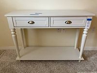 Front view of white hall/sofa table showing two drawers and lower shelf.