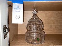 Front view of the crystal jar with dome lid, showing detailed patterns and Waterford green sticker