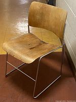 Front left angle view of the bent oak seat and back chair with chrome sled metal frame.