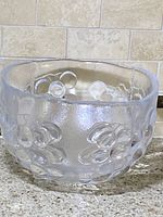 Clear textured crystal bowl with a raised grape cluster design, viewed from front