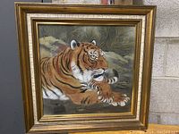 Full front view of the framed tiger artwork showing the entire piece including frame and background.