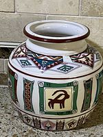 Photo of vintage hand painted Middle Eastern ceramic vase showing side with animal and geometric motifs