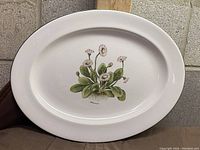 Full view of the white oval serving platter with central Belli Perennis floral design.