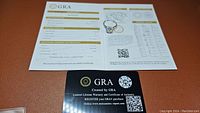 Certificate of authenticity and warranty from GRA showing grading details for the moissanite gemstone.