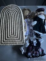 Woven basket-style carrying case with handle and arched top, made from natural fibers.