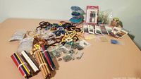 Wide view of assortment including bead strings, jewelry supplies, and craft containers