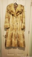 Front view of the pale real fur coat with collar and buttons