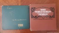 Photo showing the blue-green cover of The Flying Dutchman vinyl record set alongside the brown box of The Ring of the Nibelung vinyl record set with a book inside.