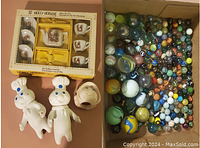 Full lot displayed including boxed Holly Hobbie tea set, two Pillsbury Doughboy figures, ceramic pig, and box of assorted marbles