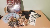 Overview of toys, accessories, and packaging showing UFC octagon playset pieces and two bags of figures.