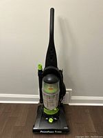 Front view of the Bissell PowerForce Turbo upright vacuum cleaner showing the entire unit including the handle, dirt container, and power cord.
