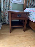 Front view of one nightstand showing drawer and lower shelf