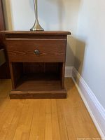Front view of pine nightstand showing drawer and open shelf