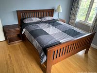 Angled view of full bedframe in bedroom setting