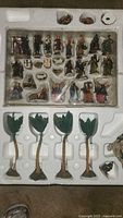 Styrofoam tray with assorted figurines including human characters, animals, and palm trees included in the set