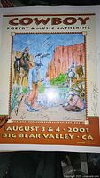Signed 2001 Cowboy Poetry & Music Gathering poster showing western art and signatures including Waddie Mitchell and others.