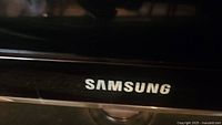 Close-up of Samsung brand name on the television, showing authenticity of the brand.