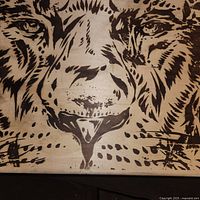 Close-up of the detailed lion face artwork printed on the box lid.