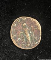 Reverse view showing standing Genius left holding patera and support with legend