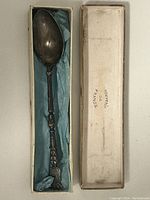 Full view of the 1916 French silver souvenir spoon inside its original box lined with blue material and labeled 'souvenir France'.