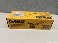 Image of the yellow and black DeWalt box showing the product illustration and branding, confirming this is a DeWalt 4-1/2 inch small angle grinder model DWE4011, new in box.